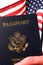 American Citizenship Passport and US Flag in Hand