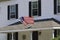 American Colonial Flag Hanging In Front Of Home