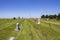 American country cemetary out on the plains with some graves decorated for Memorial Day and farmland in the distance