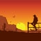 American Cowboy on wild west sunset landscape in the evening