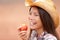 American cowgirl eating peach