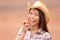 American cowgirl eating peach smiling happy