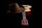 American culture, folk song and country muisc concept theme with a cowboy hat and an acoustic guitar isolated on black background