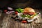 American delicious burger on rustic wooden background. fast food and junk food concept