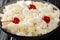 American dessert salad consisting of rice, marshmallows and pineapple dressed with whipped cream close-up in a plate. horizontal