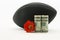 American dollar currency and red flower in front of black football