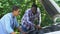 American father explaining car structure to son showing auto parts, togetherness