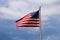 American flag against blue sky with clouds at the Savannah riverfront