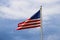 American flag against blue sky with clouds at the Savannah riverfront