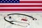 American flag on the background of pills and a stethoscope on the table. USA flag and medical supplies