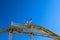 An American flag and a California flag on top of a yellow rollercoaster with a gorgeous blue sky at Santa Monica Pier