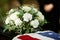 American flag on coffin at outdoor funeral ceremony for veteran