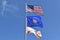 American flag Conch Republic Flag and State of Florida Flag flying against a blue sky