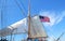 American Flag flying atop sails of a tall Ship in Dock. San Diego, USA.