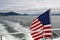 American flag flying off the back of a boat on the Salish Sea in the San Juan Islands on a stormy day