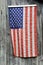 American flag hanging on gray barn wood