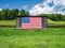 American Flag Hanging on an Old Barn