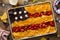 American flag nachos on a big tray with chips and salsa