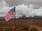 American Flag with Native American on Horseback with Monument Valley in Distance