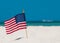 American Flag. Ocean and Beach sand. 4th of July Independence Day. US starry striped patriotic symbol. United States Holidays. Sum