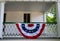 American flag old fashioned decoration on historic colonial home front porch