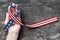 American flag pattern awareness ribbon on people`s hand isolated with clipping path for USA United Stated of America national