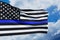 American flag with police support symbol Thin blue line on a background of blue cloudy sky.