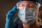 American Flag Reflecting on Distressed Female Medical Worker Wearing Protective Face Mask and Goggles