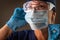 American Flag Reflecting on Female Medical Worker Wearing Protective Face Mask and Goggles