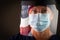 American Flag Reflecting on Female Medical Worker Wearing Protective Face Mask and Shield