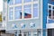 American Flag Reflection in Window of Blue House with Stars