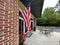 American flag retail strip mall store exterior and dining patio tables