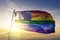 American flag stars gay pride rainbow flag textile cloth fabric waving on the top sunrise mist fog