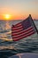 American Flag on Stern of Yacht Sailing Offshore, Sunset