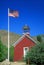 American flag waving above one room schoolhouse, Wellington, NV