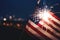 American flag waving in the night with fireworks