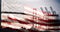 American flag waving with shipping port harbor dock and bridge silhouette background