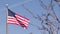 American flag waving in wind, USA. National symbol waves in breeze on flagpole.