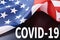 American flag with a word COVID-19. Impact of coronavirus on USA and global economy