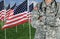 American Flags in Field With Soldier Medic