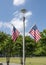 American flags on a lamp near Griggs Park Memorial Plaza Obelisk in Uptown in Dallas, Texas.