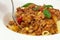 American food. Pasta alla genovese. Pasta with corn, fried meat and sauce
