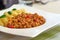 American food. Pasta alla genovese. Pasta with corn, fried meat and sauce