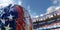 American football ball close-up, blurry stadium and stands in the background