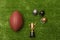 American football ball, little football helmets and golden trophy