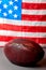 American football ball and old glory flag
