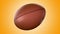 American football ball rotating in motion on orange screen. Looped American football 3d Animation. 3d. 4K