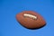 American football in blue sky with clipping path.