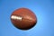 American football in blue sky with clipping path.