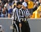 American football game officials talking - referee